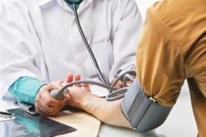 Doctor taking patient's blood pressure