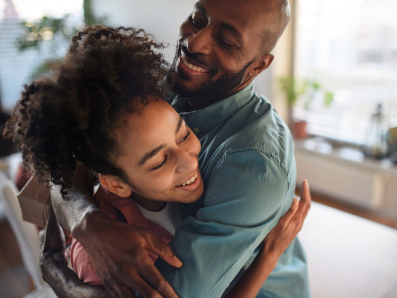 Father hugging daughter
