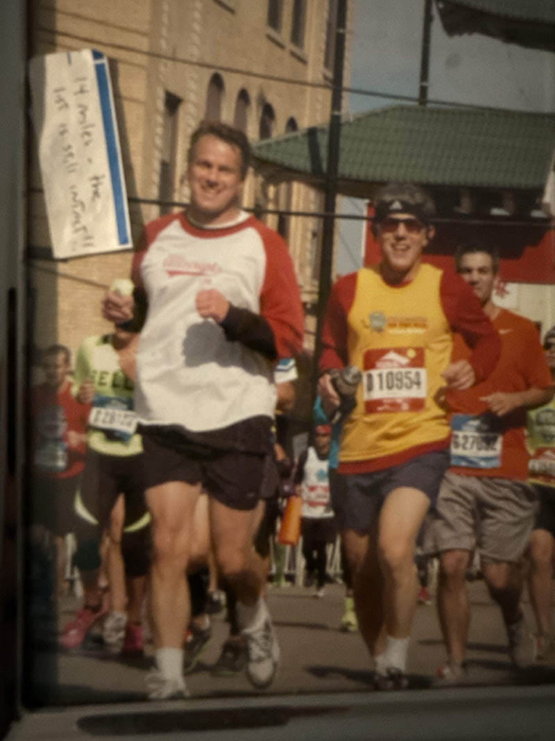 Glen Tullman (white shirt) and Lee Shapiro (yellow shirt), shown running the Chicago Marathon about two decades ago. (Photo courtesy of Lee Shapiro)
