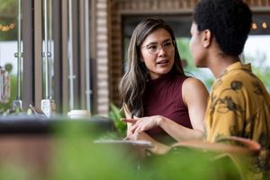 Young adult friends chatting in a cafe