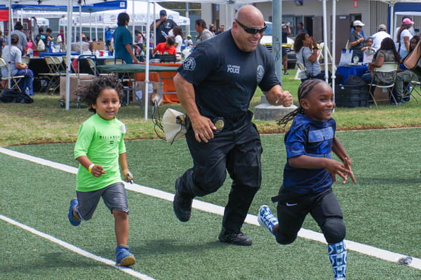 LAPD officer at health event with children