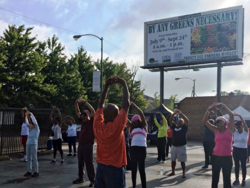 Yoga Ministry at the Trinity Community Farmers Market, where people have access to fruits and vegetables. (Photo courtesy of Endeleo Institute)