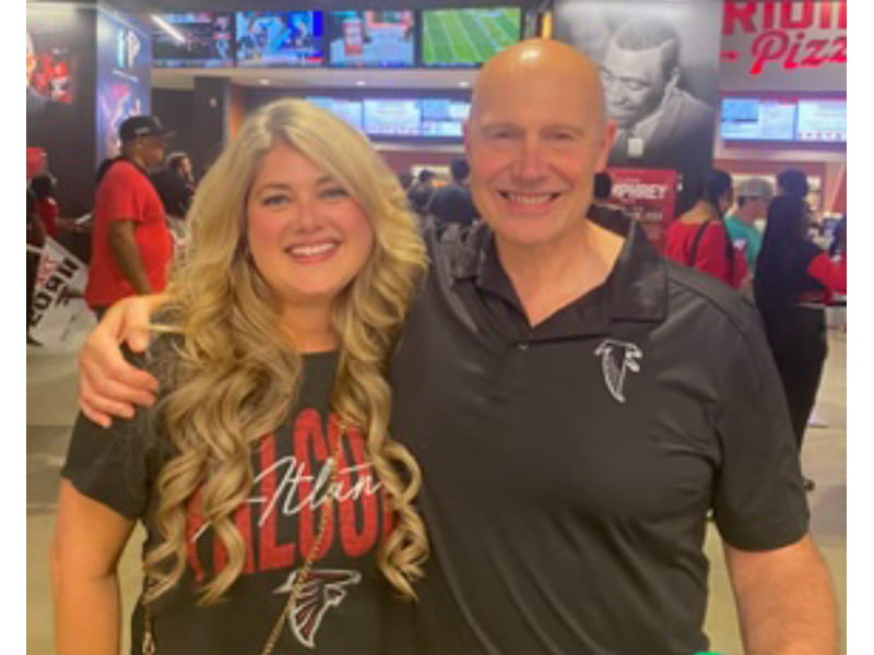 Don Milich standing with his arm around his wife, Kylie, both smiling