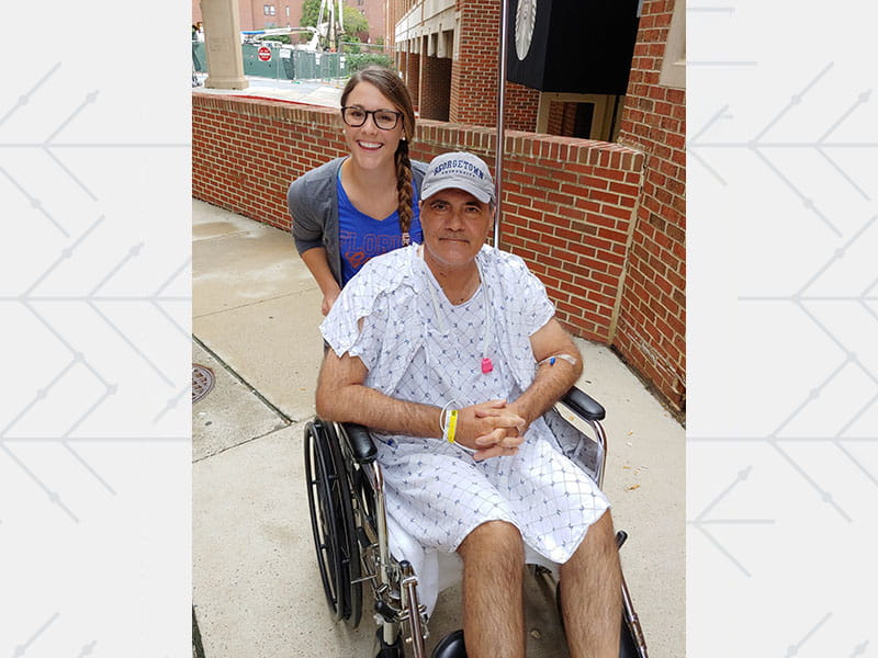 Jessica pushing her father Carlos in a wheelchair