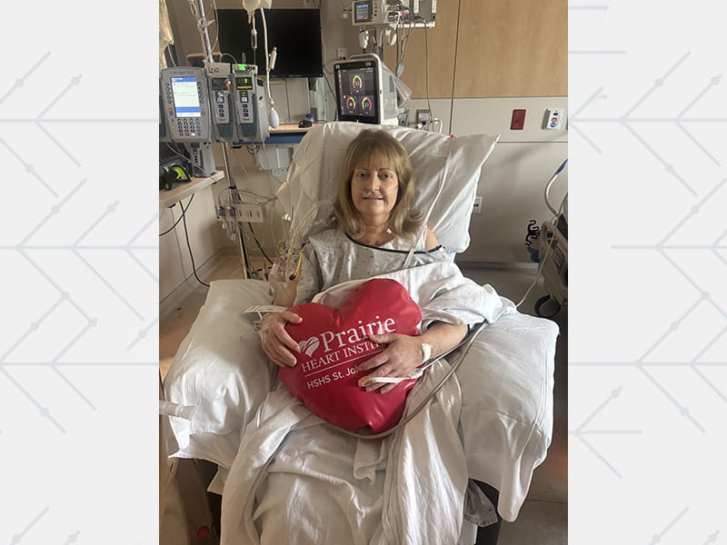 Natalie Daugherty in the hospital holding a heart-shaped pillow