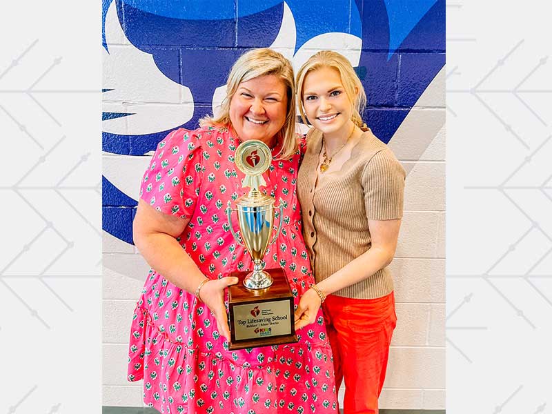Sarah Kay presents Jess Agee, principal at Center for Knowledge Elementary, with the American Heart Association's Top Lifesaving School Award for the Richland Two School District in Columbia, South Carolina.