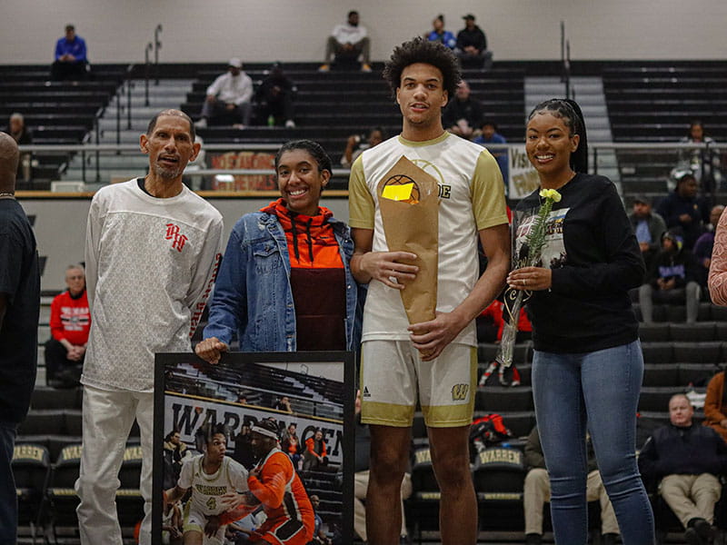 Jasmine (right) posing with her father, Kenny Hooks (left), with her siblings, Jada McCollum and Jalen Hooks at a basketball event