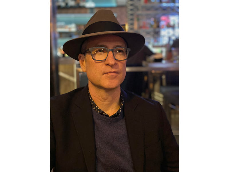 Aaron Holm wearing a hat, indoors