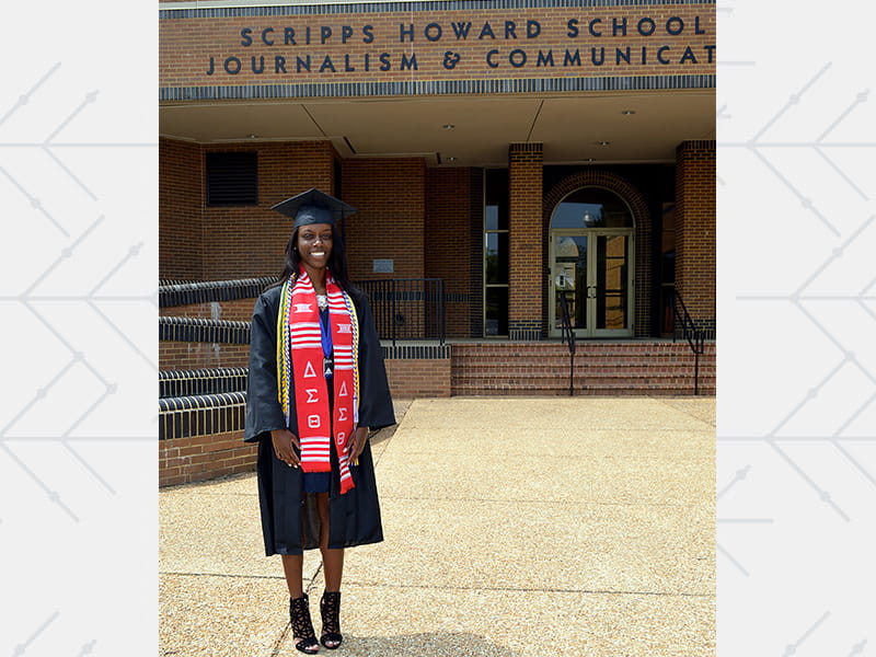 Whitney Johnson smiling while standing outside the Scripps Howard School of Journalism and Communication.