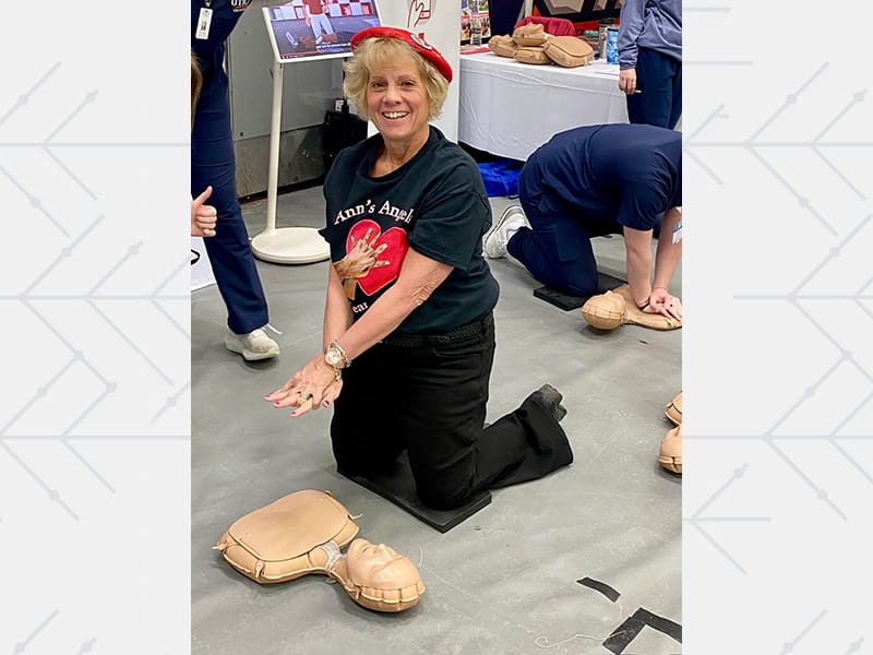 Cardiac arrest survivor Ann Furner demonstrates chest compressions at America’s Greatest Heart Run and Walk in Utica, New York.