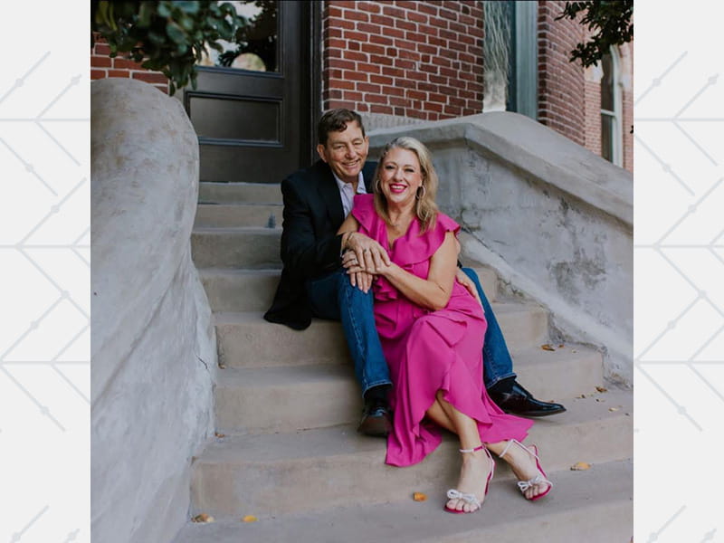 Bruce Brown dressed up with his wife Tiffany sitting on some steps together