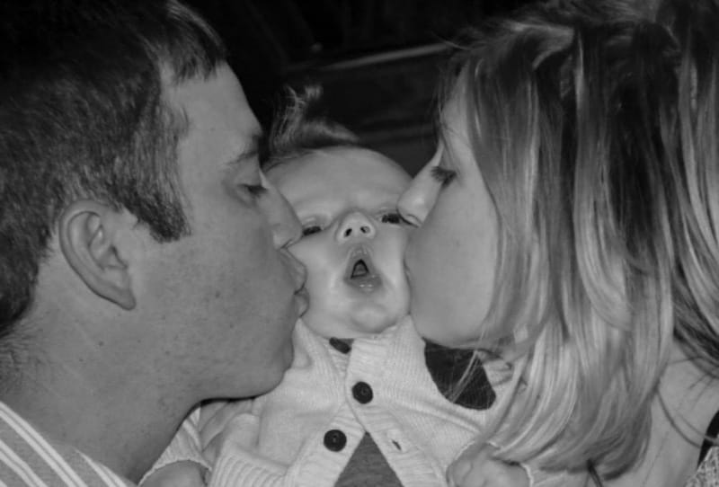 Before Jackson's second open-heart surgery, Jamie made sure to take this picture of her and Layne kissing their son. (Photo courtesy of the Dawson family)