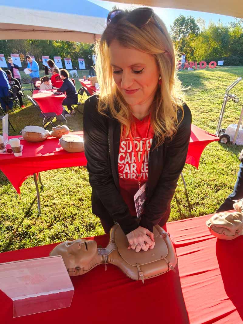 Brooke Jones posing with a CPR training mannequin at an American Heart Association event. (Photo courtesy of Brooke Jones)