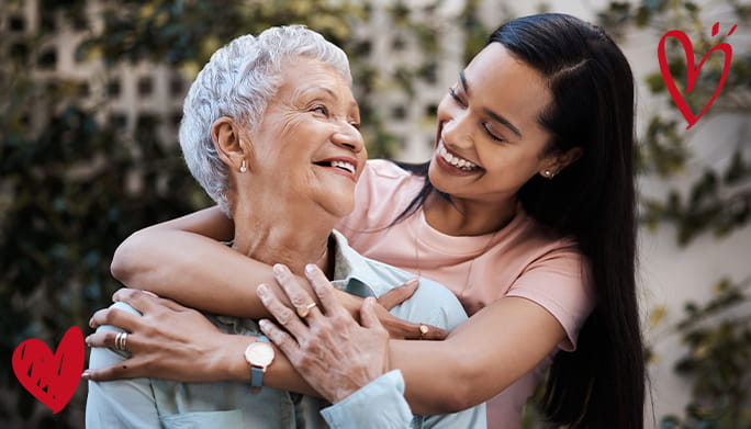 Two women hugging and smiling for Mother's Day