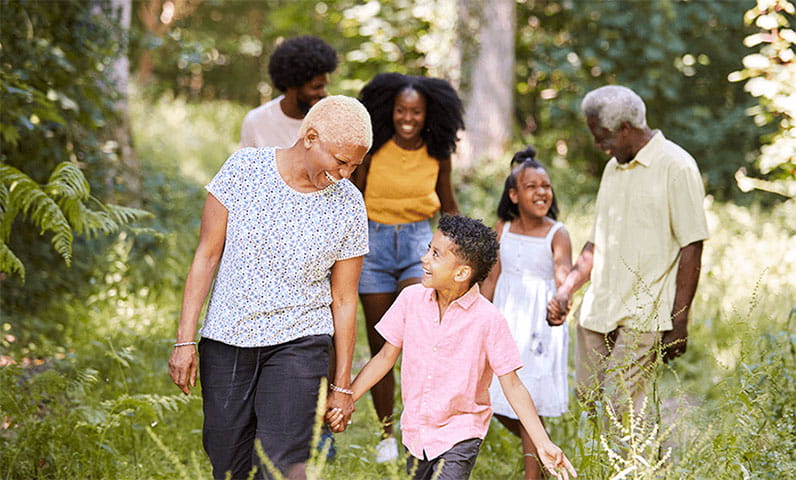 multi generational family walking on nature trail