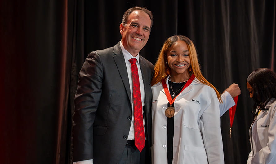 American Heart Association Scholars being presented with their medallions on stage