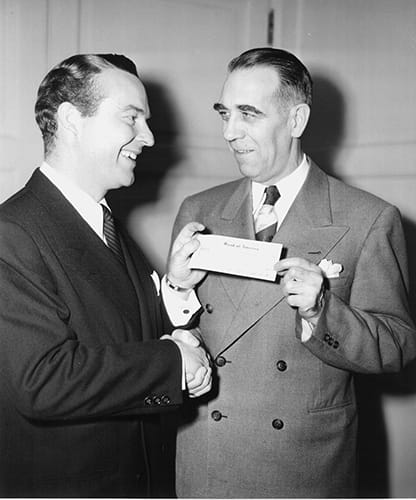 Ralph Edwards (left), host of the radio show “Truth or Consequences,” presents the check from The Walking Man contest to American Heart Association President Dr. Arlie R. Barnes in 1948. (American Heart Association archives)