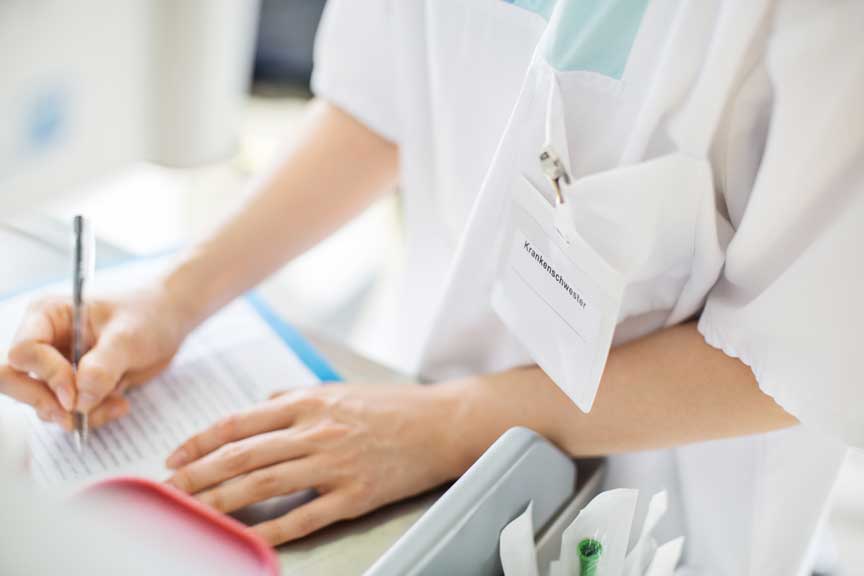 Doctor writing something down on paper