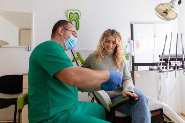 Dentist talking to female patient