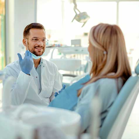 Dentist talking to his patient