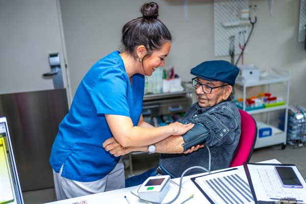 Man getting blood pressure checked in medical setting