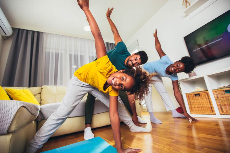 Family exercising together in the living room