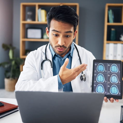 man and doctor on video call, talking and healthcare with telehealth, diagnosis and analysis for care. Male employee, medical professional or surgeon with tablet, brain scans