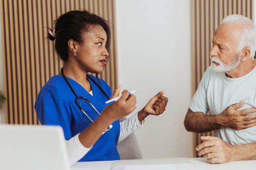 Nurse and man clutching heart