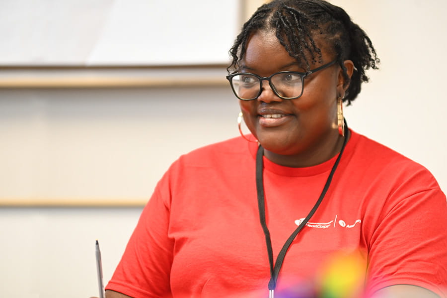 Smiling volunteer in a red shirt at a Rural at Heart event