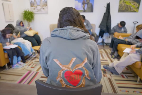 Latino Behavioral Health Services participants gathered in a circle group setting.