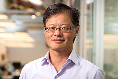 A professional portrait of Jerry Yang with a blurred office in the background