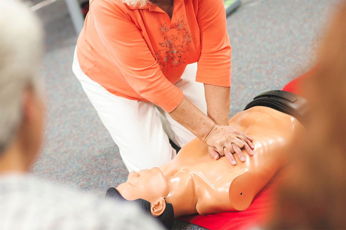 Teaching CPR on a manikin in a class setting image