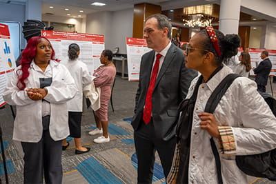 American Heart Association Undergraduate Scholars presenting their posters to Symposium attendees.