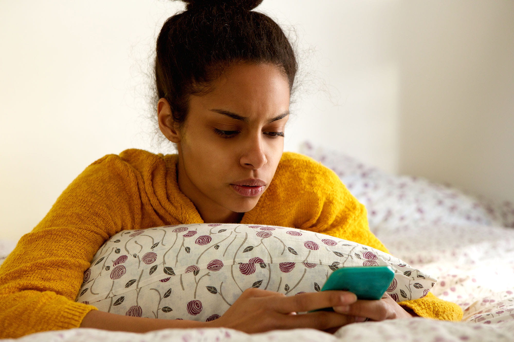 worried young woman looking at phone