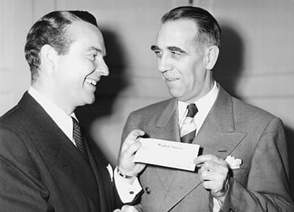 Ralph Edwards (left), host of the radio show "Truth or Consequences," presents the check from The Walking Man contest to American Heart Association President Dr. Arlie R. Barnes in 1948. (American Heart Association archives)