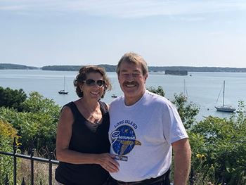 Pam Neal with husband, Daniel, outside near the water
