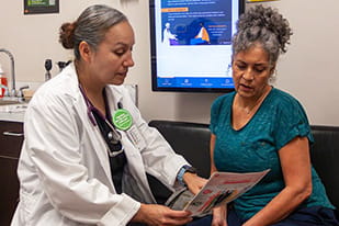 female doctor going over information with a female patient