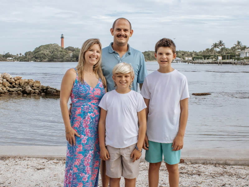 Kandi Schmitz had a stroke at 31 while training for a half-marathon. Almost a decade later, she was diagnosed with breast cancer. Pictured with her family in 2024, clockwise from left: Kandi, Matthew, Reid and Caiden. (Photo courtesy of Heather Lynn Photography)