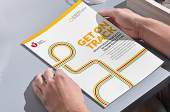 Get on Track white paper lying on a table between two hands