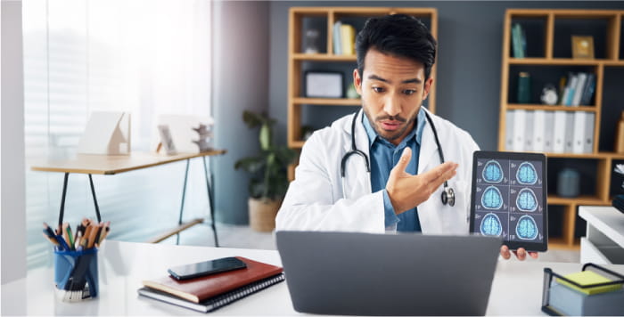 Physician at Desk having Telemedicine visit with Stroke patient