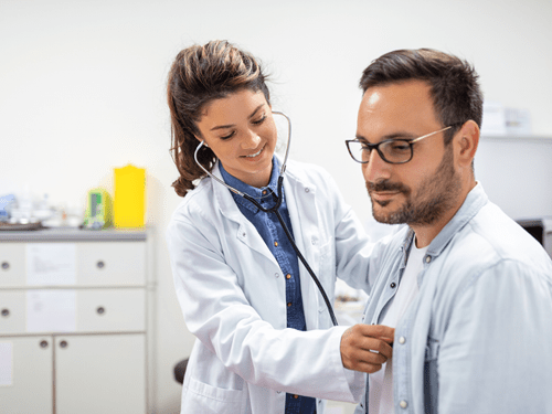 Female doctor with stethoscope and male patient