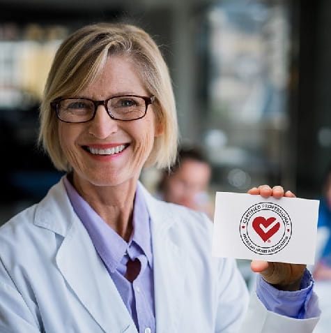 Female Professional holding AHA Checkmark 